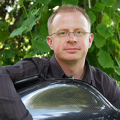 A man holding a cello case
